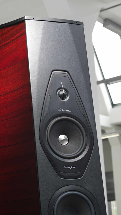 Close-up of the Lilium floorstanding loudspeaker by Sonus faber, featuring Red high gloss wood and black leather finishes.