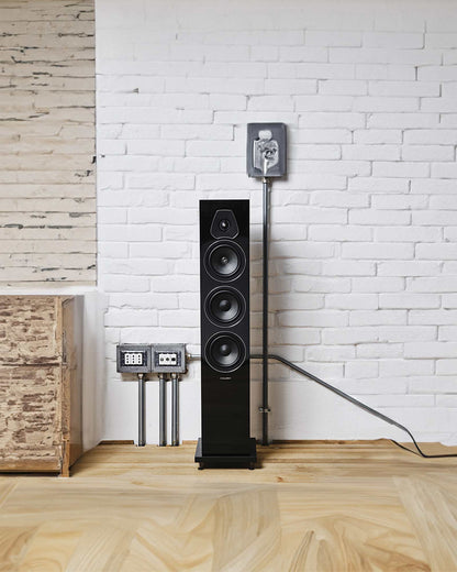 Sonus faber Lumina III speaker in piano black lacquer and black leather finishes, shines in a bright room with white walls.