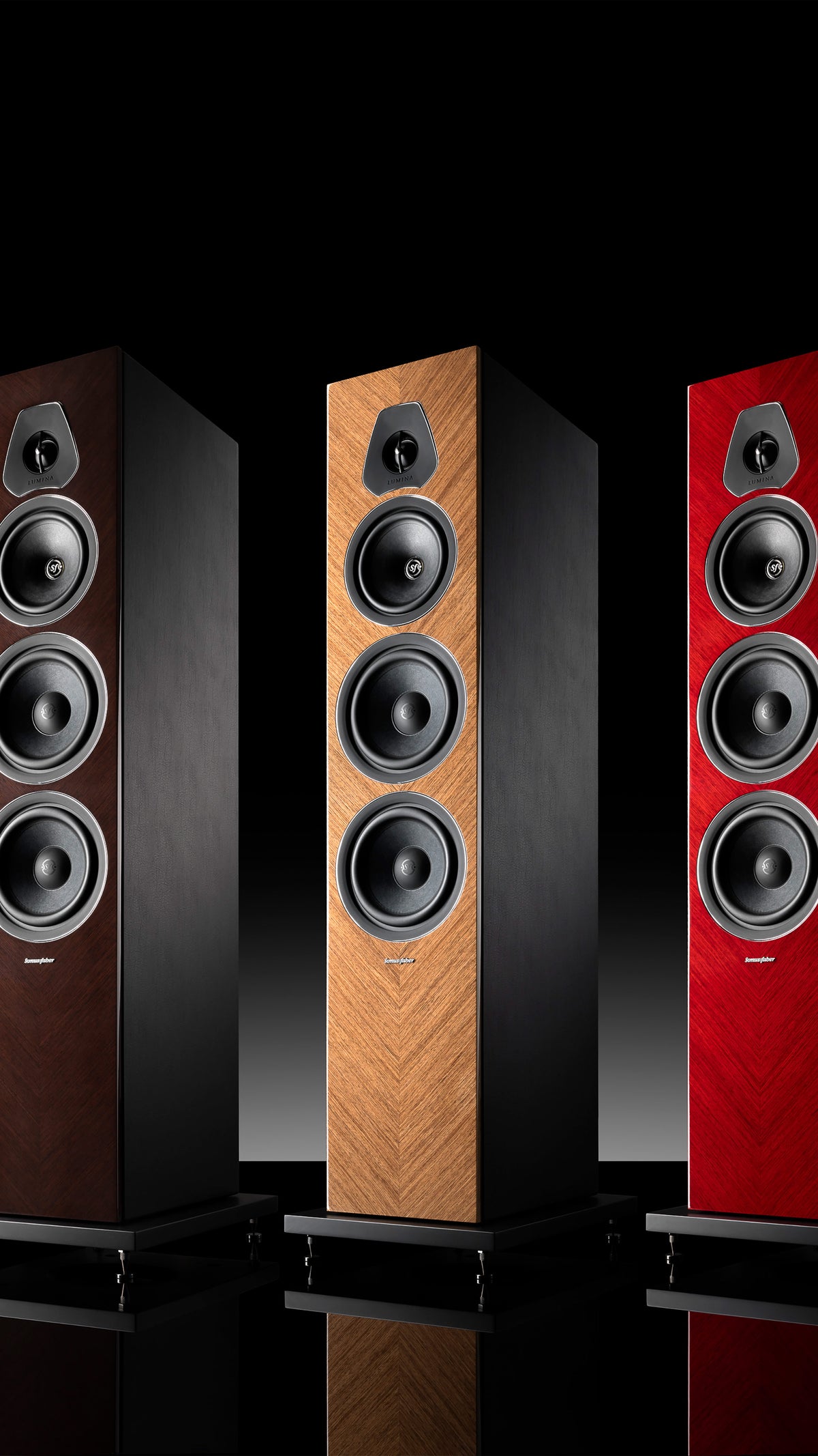 A trio of Sonus faber Lumina V Amator speakers, offered in red, wenge, and walnut high gloss finishes.
