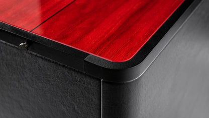 Close-up of the Gravis V subwoofer, highlighting intricate details with a stunning red wood color and luxurious black leather finishes.