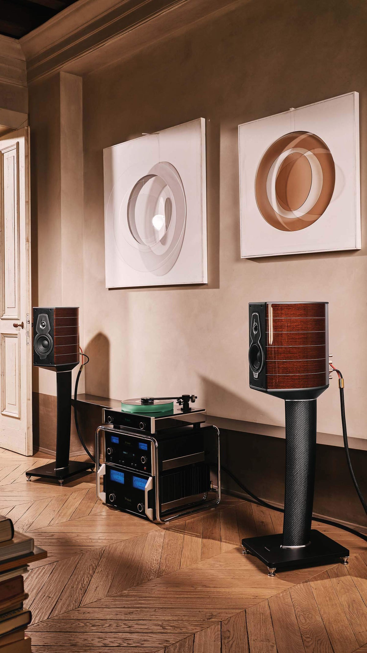 Pair of Sonus faber Guarneri G5 bookshelf speakers with stands in a home audio room, complemented by McIntosh speakers.