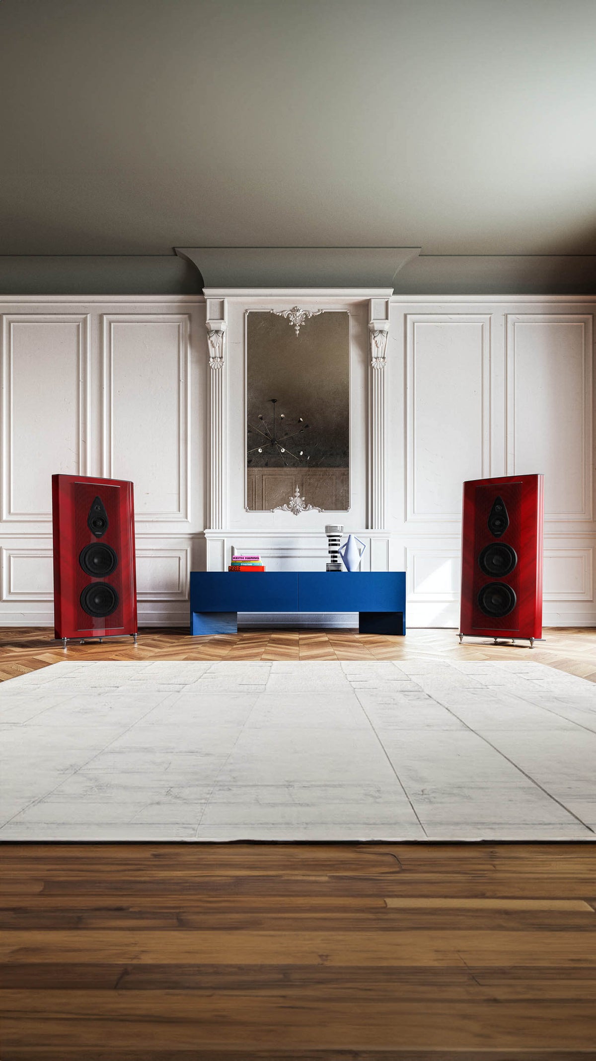 Red-finished Sonus faber Stradivari G2 speakers, framing a table with books in a luxurious room for an elegant audio setup.