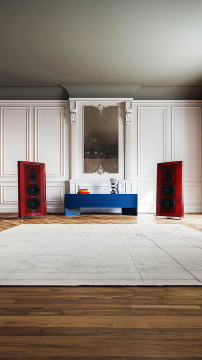 Red-finished Sonus faber Stradivari G2 speakers, framing a table with books in a luxurious room for an elegant audio setup.